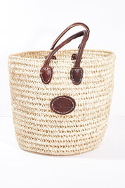 A model wearing size OneSize of the Oversize Round Open Weave Handle Basket in colour Natural, from the front, showing the whole outfit