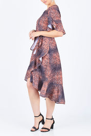 Model Lisa wearing size 10 of the Animal Wrap Dress in colour Animal, from the front, cropped image