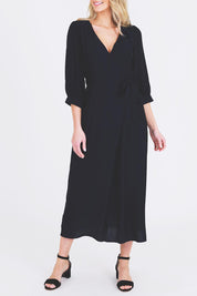 A model wearing the Eden Classic Wrap Dress in colour Navy (Blue), from the front, cropped image