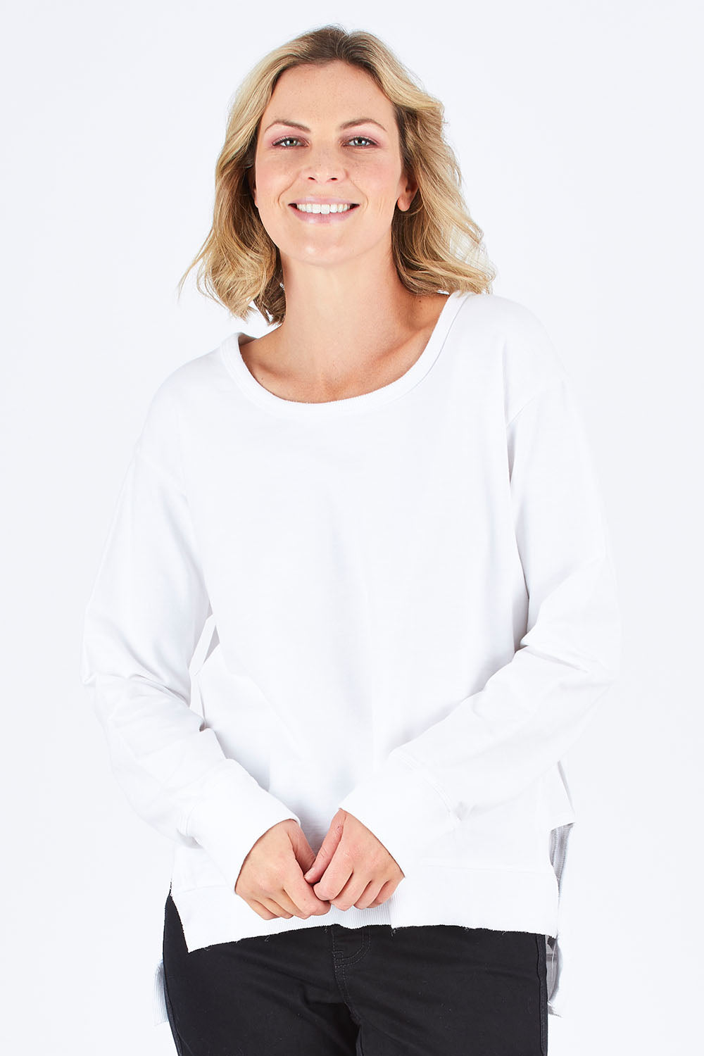 Model Chelsea wearing size S of the Ulverstone Sweater in colour White (White), from the front, cropped image