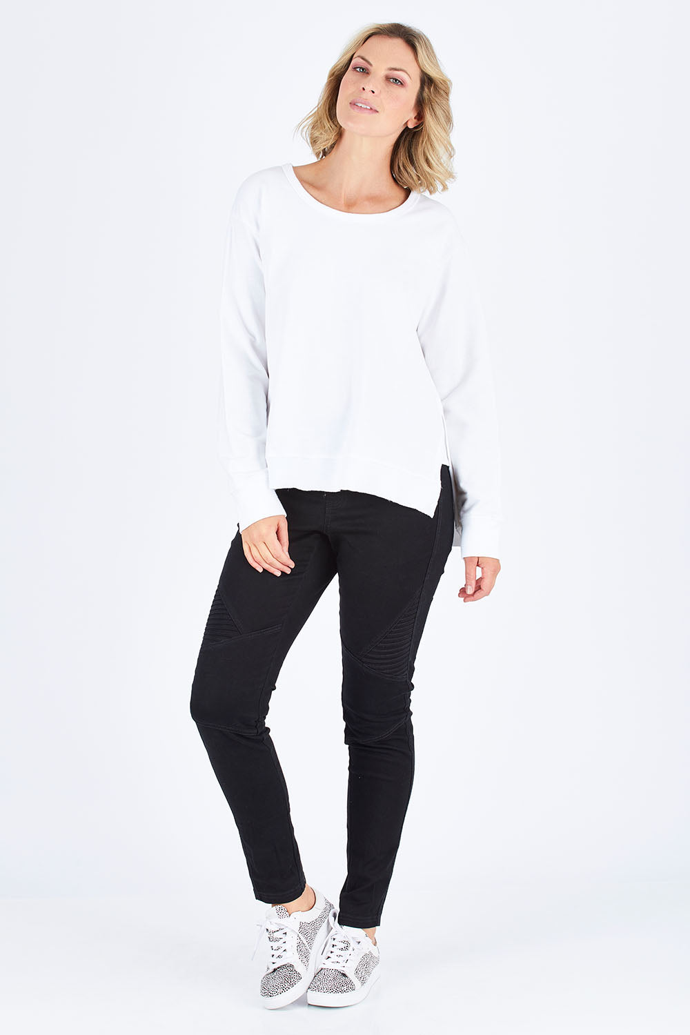 Model Chelsea wearing size S of the Ulverstone Sweater in colour White (White), from the front, showing the whole outfit