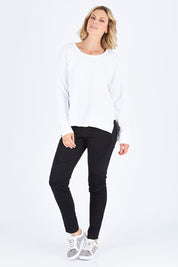 Model Chelsea wearing size S of the Ulverstone Sweater in colour White (White), from the front, showing the whole outfit