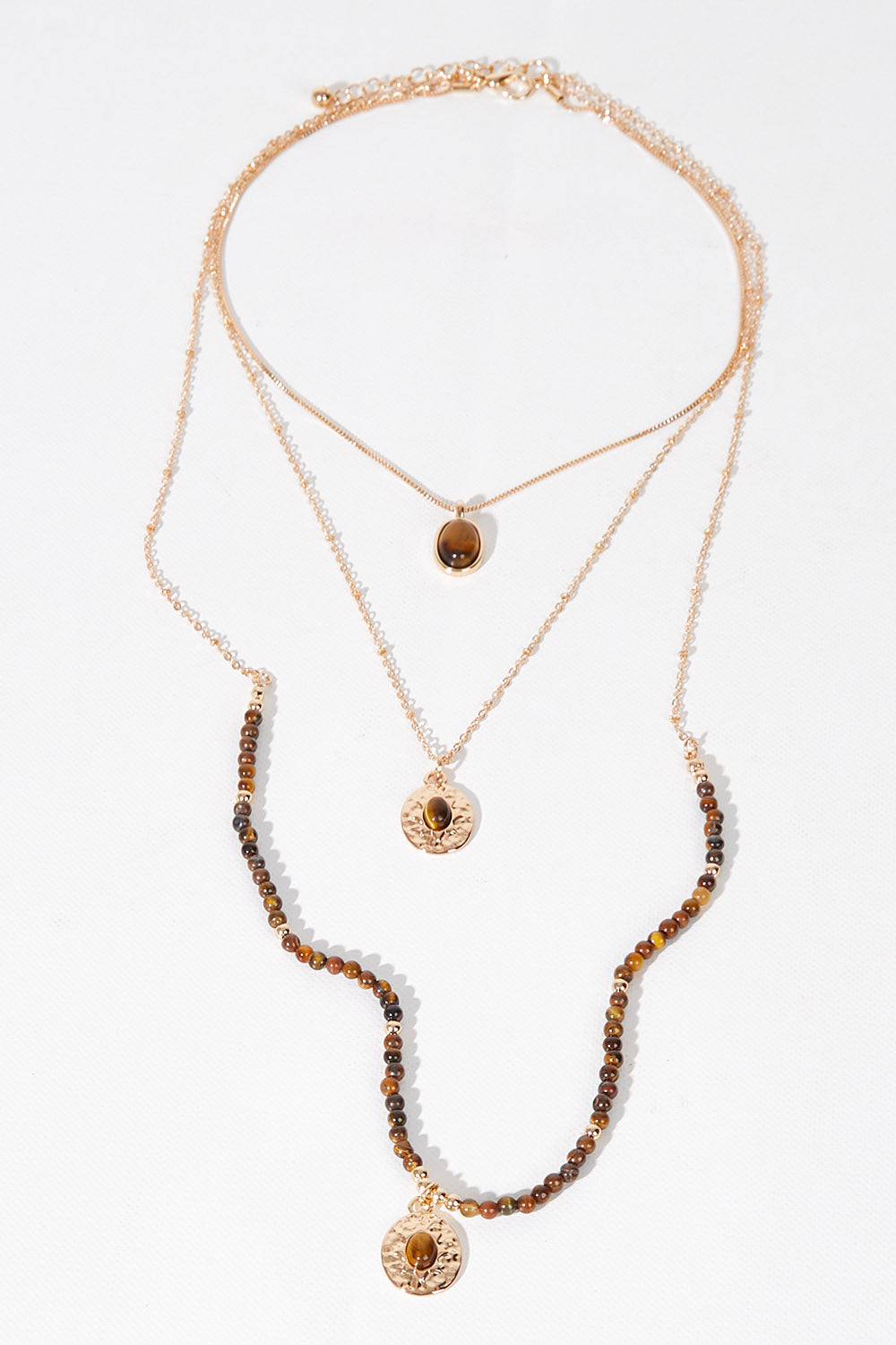 A model wearing size OneSize of the Trio Layers Medallion Long Necklace in colour Tangold, from the front, showing the whole outfit