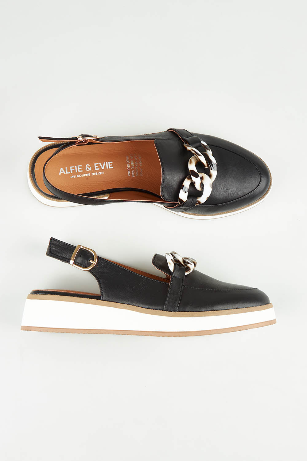 A model wearing size 37 of the Quivers Sandal in colour Black (Black), from the front, showing the whole outfit