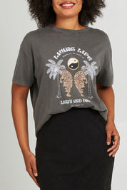 Model Olivia wearing size 10 of the Living Life Standard Tee in colour Charcaol (Grey), from the front, cropped image