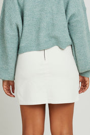 Model Olivia wearing size 10 of the Emma Cord Skirt in colour Vwhite (White), from the back