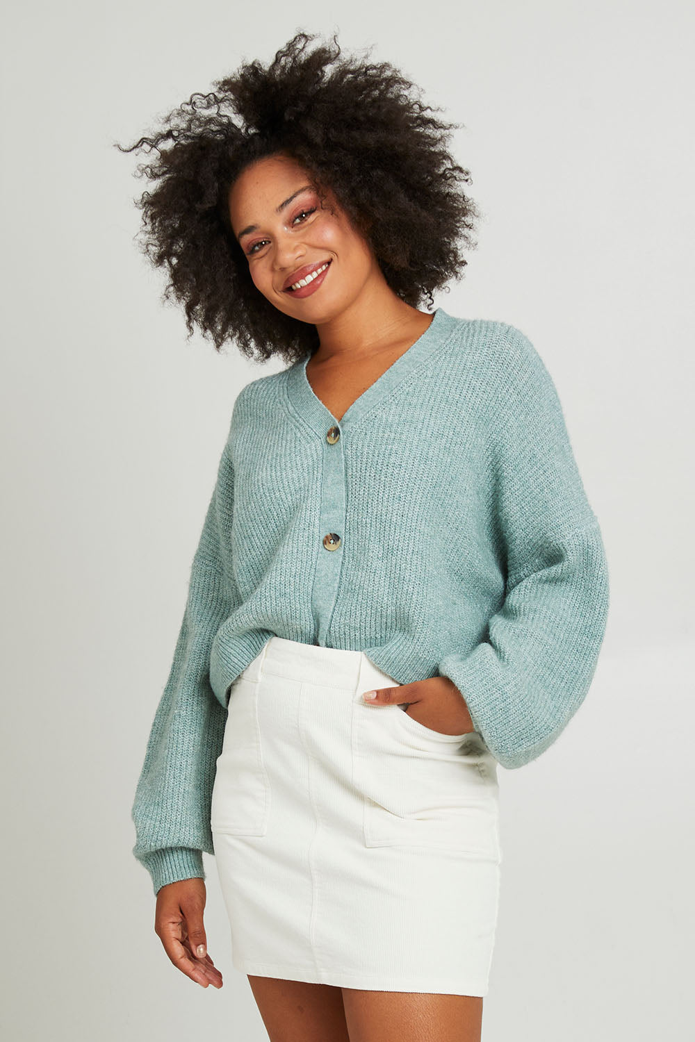Model Olivia wearing size 10 of the Emma Cord Skirt in colour Vwhite (White), from the front, cropped image