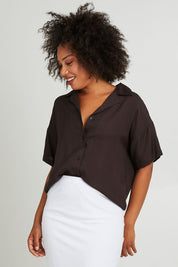 Model Olivia wearing size 10 of the Gracie Shirt in colour Back (Black), from the front, cropped image