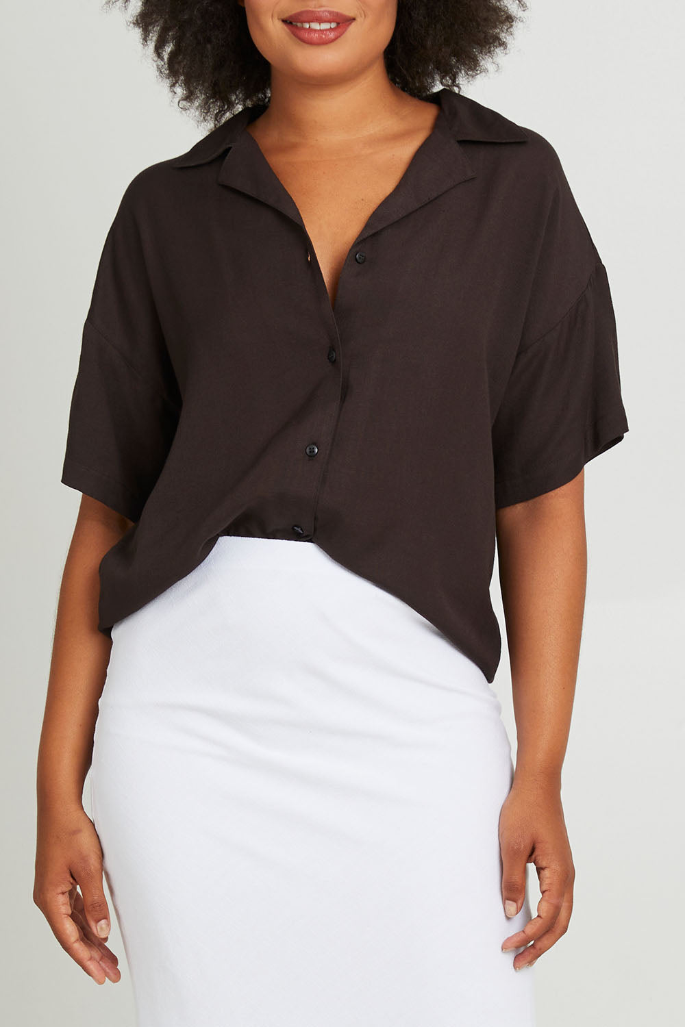 Model Olivia wearing size 10 of the Gracie Shirt in colour Back (Black), from the front, cropped image
