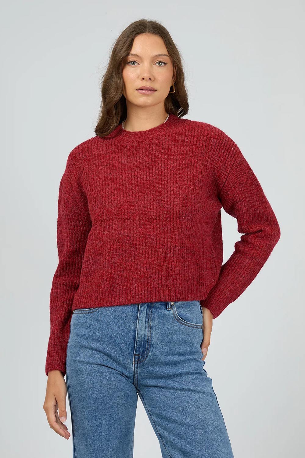 A model wearing the Jordana Knit in colour Scarlet (Red), from the front, cropped image