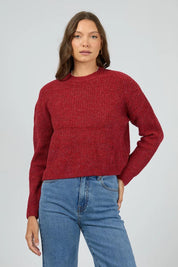 A model wearing the Jordana Knit in colour Scarlet (Red), from the front, cropped image