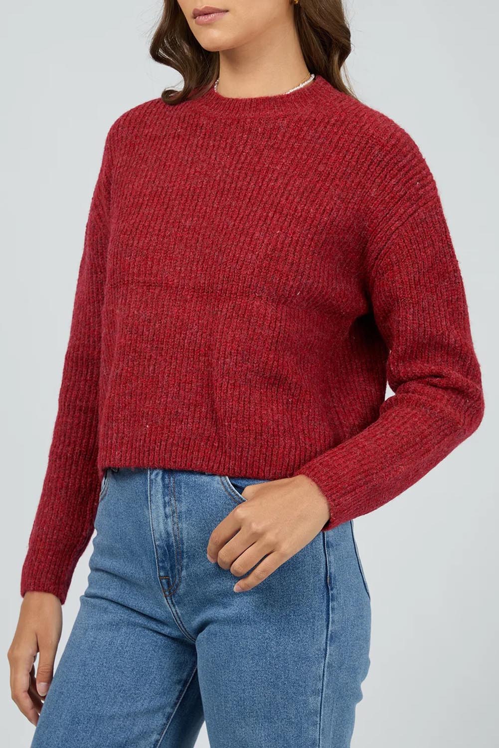 A model wearing the Jordana Knit in colour Scarlet (Red), from the front, cropped image