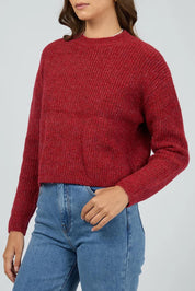 A model wearing the Jordana Knit in colour Scarlet (Red), from the front, cropped image