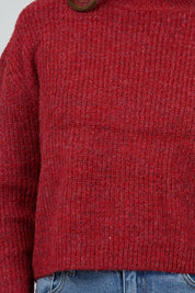 A model wearing the Jordana Knit in colour Scarlet (Red), from the front, cropped image