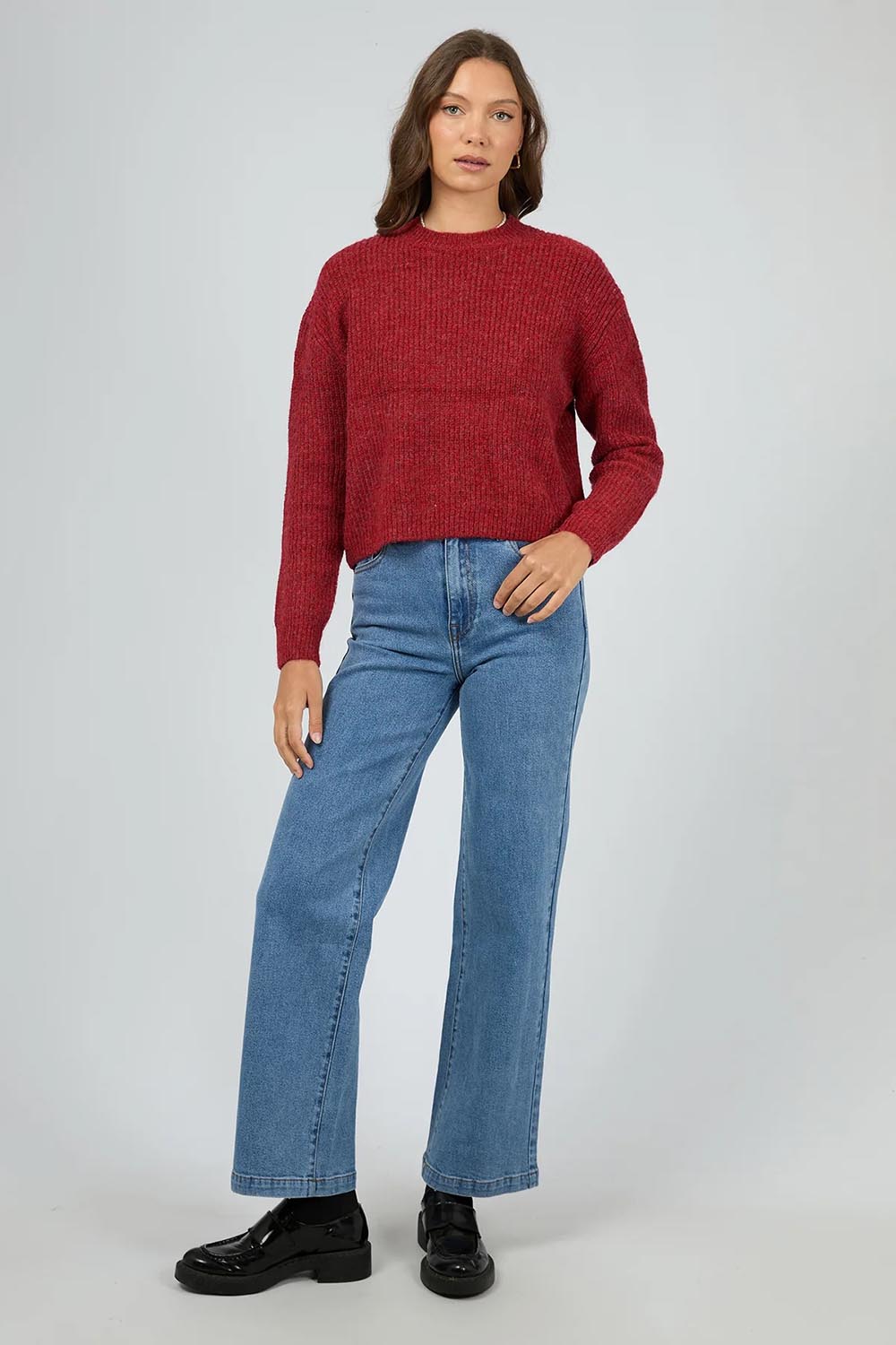 A model wearing the Jordana Knit in colour Scarlet (Red), from the front, showing the whole outfit