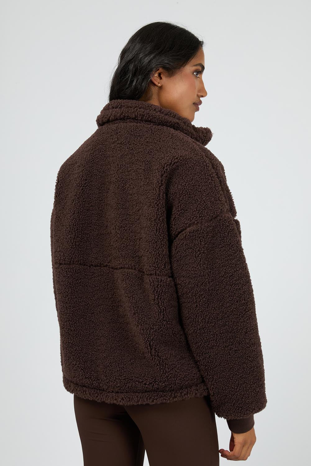 A model wearing the Amara Quarter Zip Teddy in colour Brown, from the back