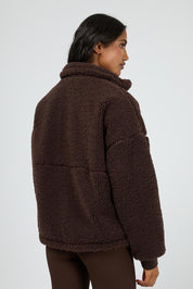 A model wearing the Amara Quarter Zip Teddy in colour Brown, from the back