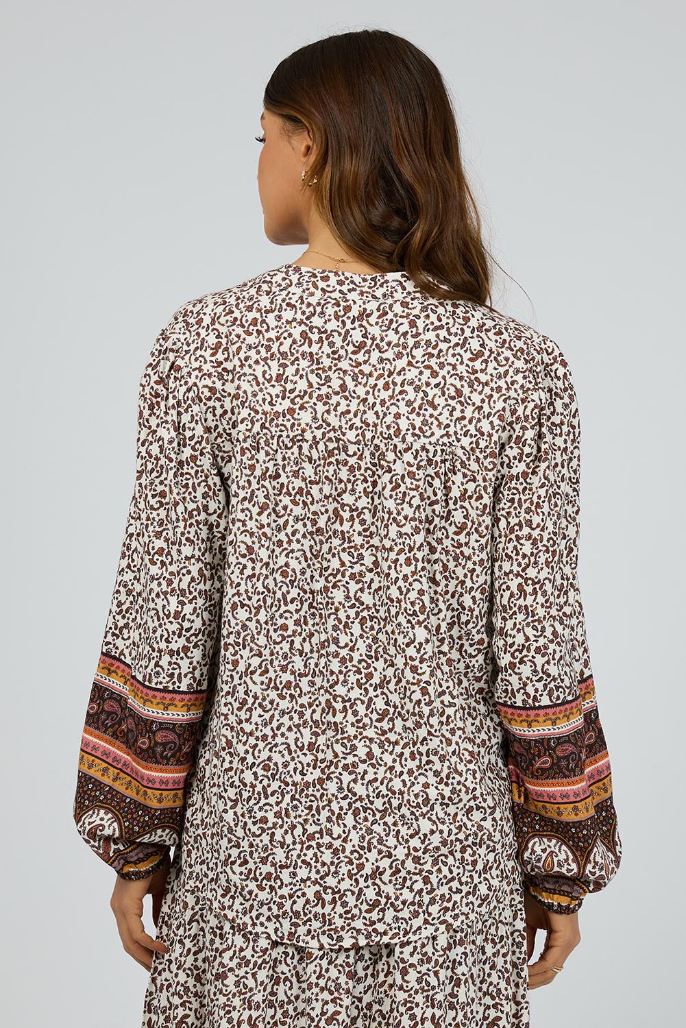 A model wearing the Honey Floral Shirt in colour Print, from the back