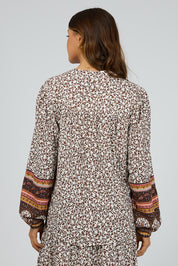 A model wearing the Honey Floral Shirt in colour Print, from the back