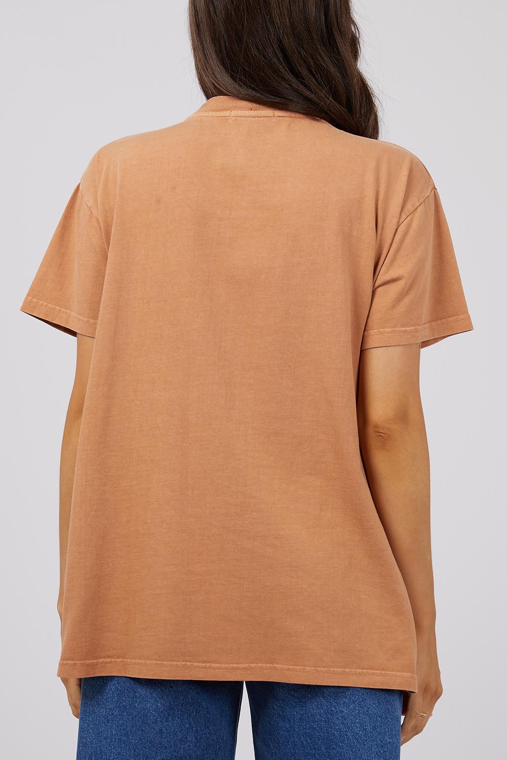 A model wearing the Baja Cotton Standard Tee in colour Tan, from the back