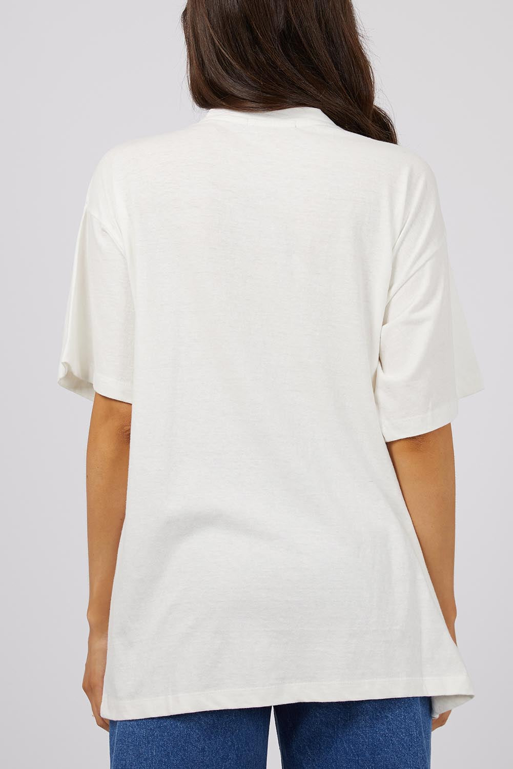 A model wearing the Solar Oversized Tee in colour Vivwhite (White), from the back