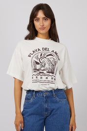 A model wearing the Solar Oversized Tee in colour Vivwhite (White), from the front, cropped image