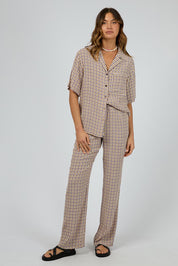 A model wearing the Harri Pants in colour Print, from the front, showing the whole outfit