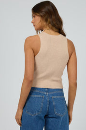A model wearing the Henley Knit Vest in colour Oat, from the back