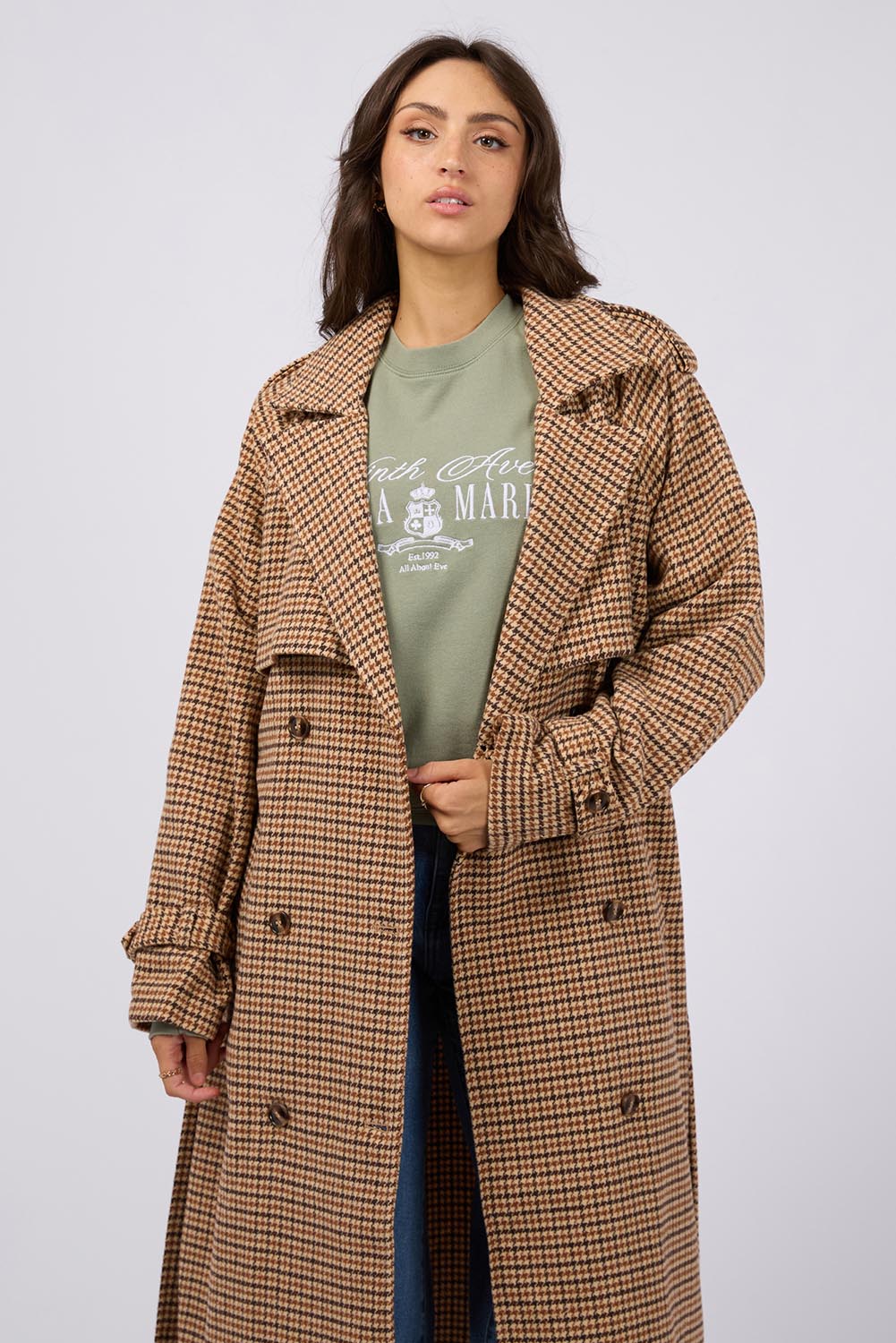 A model wearing the Charlotte Trench in colour Multi, from the front, cropped image