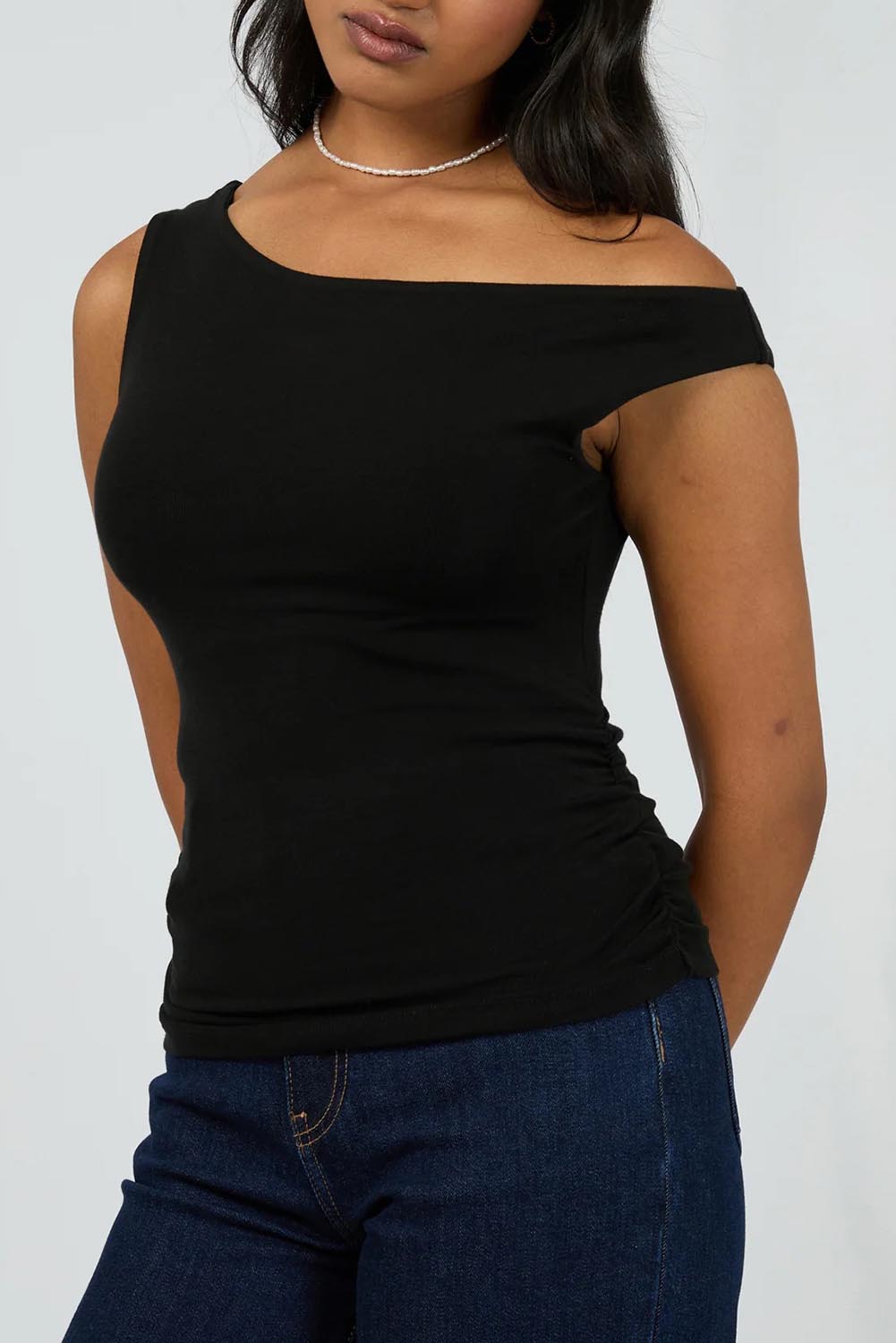 A model wearing the Kylie Off Shoulder Top in colour Black (Black), from the front, cropped image