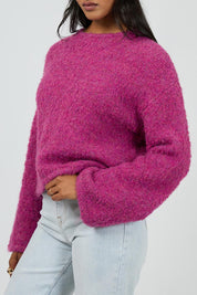 A model wearing the Cleo Knit in colour Mauve (Pink), from the front, cropped image