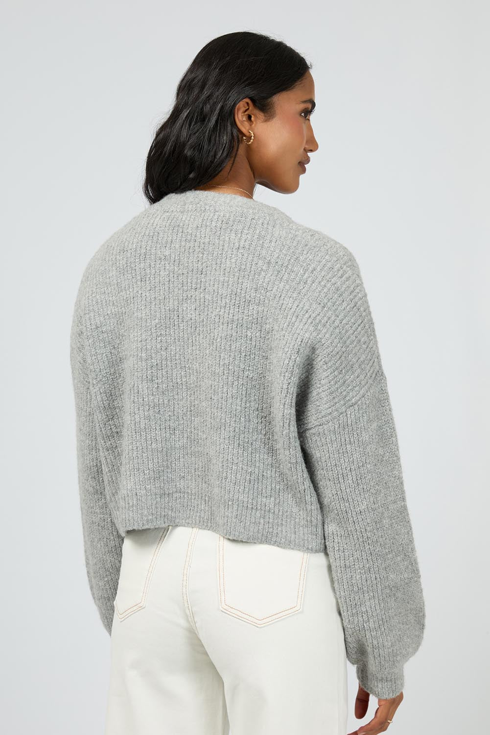 A model wearing the Selena Knit Cardi in colour Greymarle (Grey), from the back