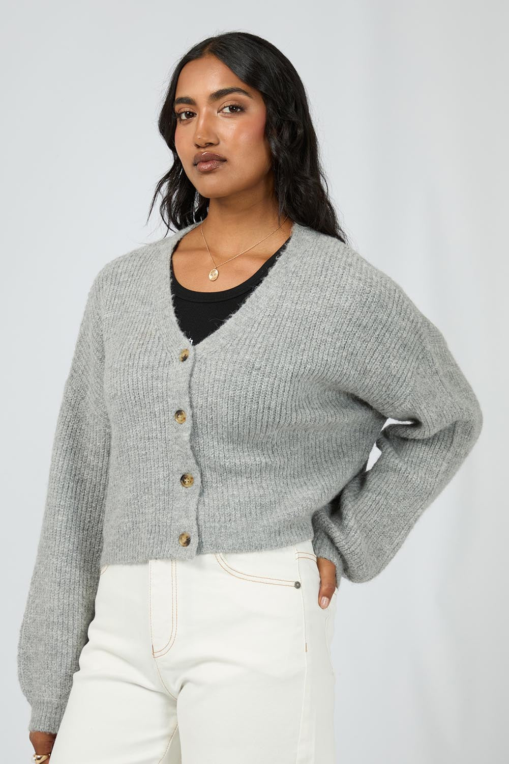 A model wearing the Selena Knit Cardi in colour Greymarle (Grey), from the front, cropped image