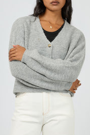 A model wearing the Selena Knit Cardi in colour Greymarle (Grey), from the front, cropped image