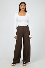 A model wearing the Romy Wide Leg Pant in colour Brown, from the front, showing the whole outfit