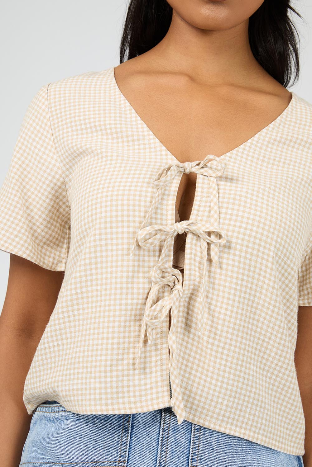 A model wearing the Hampton Top in colour Oat, from the front, cropped image