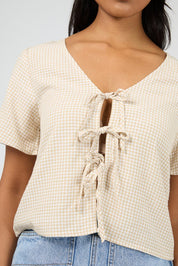 A model wearing the Hampton Top in colour Oat, from the front, cropped image