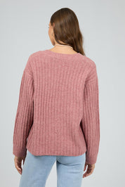 A model wearing the Clara Knit in colour Quartz (Pink), from the back