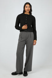 A model wearing the Aya Cardigan in colour Black (Black), from the front, showing the whole outfit