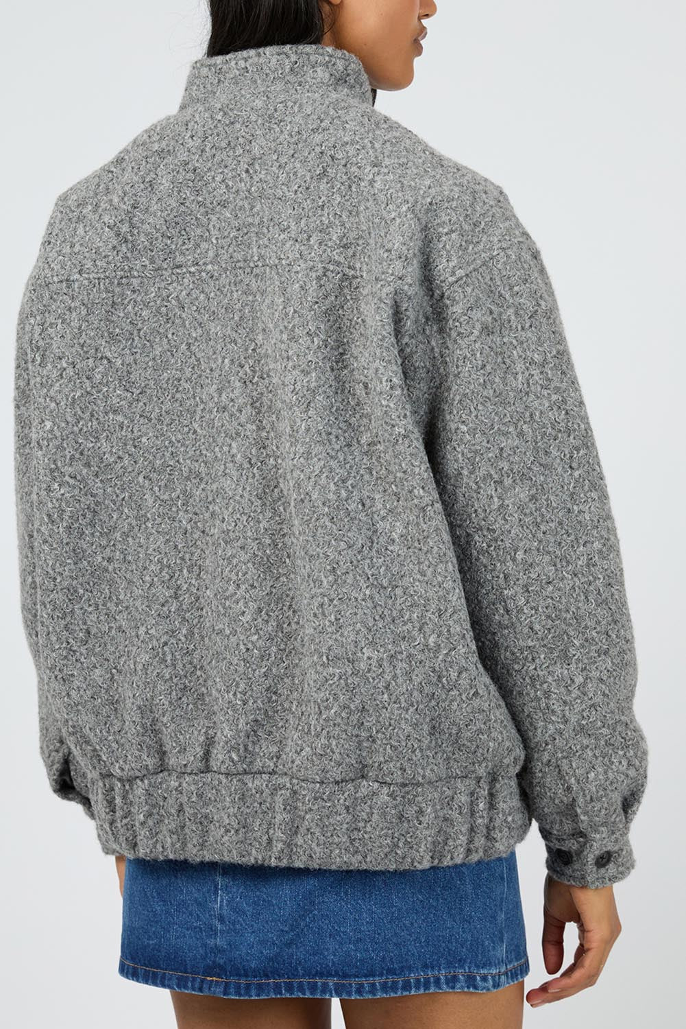 A model wearing the Tahlea Bomber Jacket in colour Greymarle (Grey), from the back