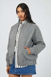 A model wearing the Tahlea Bomber Jacket in colour Greymarle (Grey), from the front, cropped image