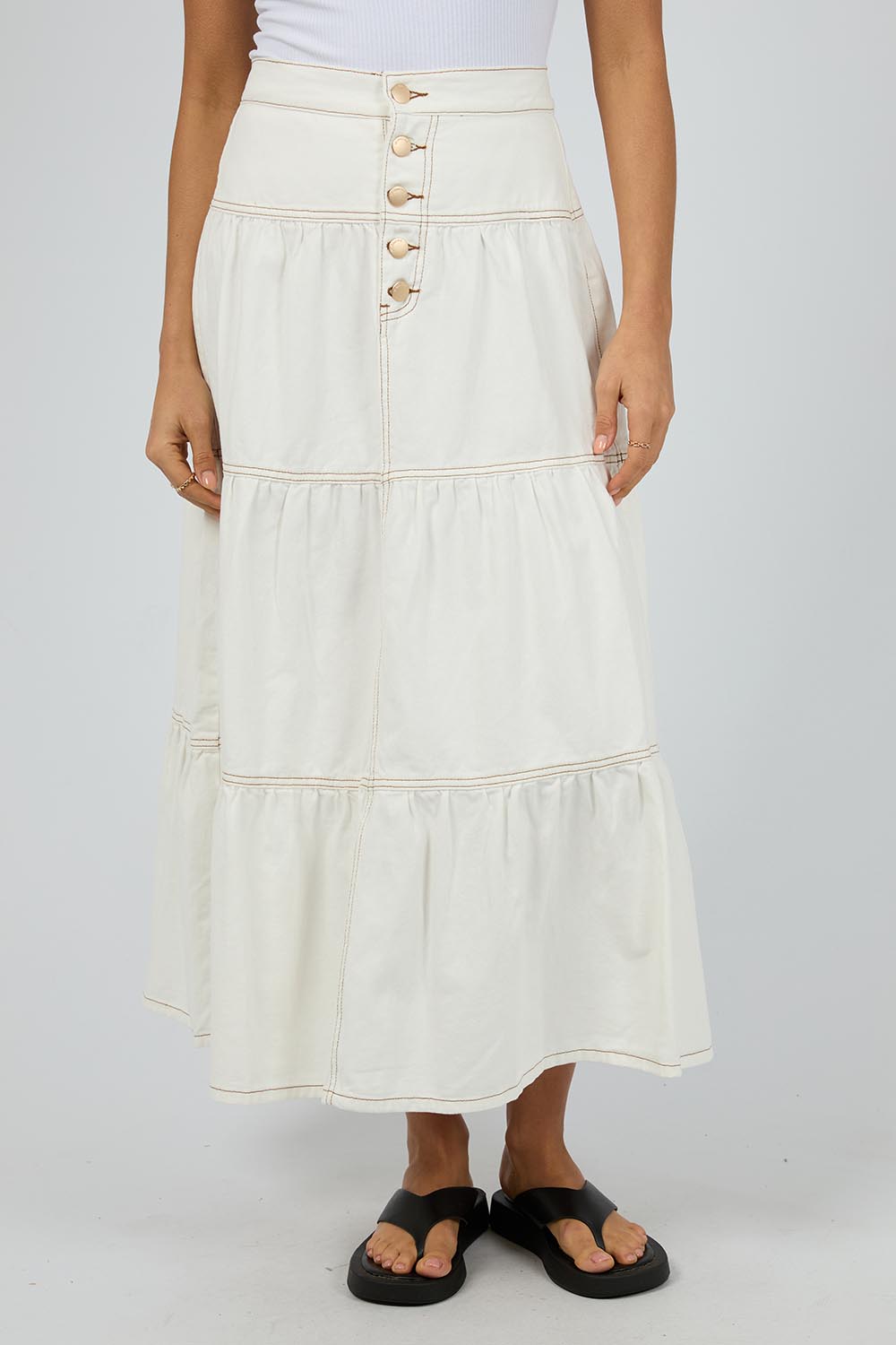 A model wearing the Coco Denim Maxi Skirt in colour Vinwhite (White), from the front, cropped image