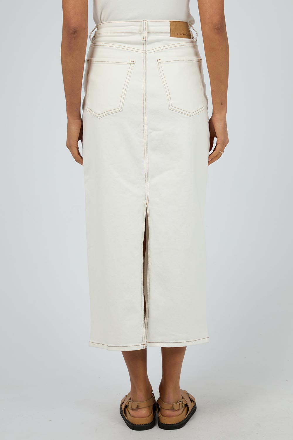 A model wearing the Ray Denim Comfort Maxi Skirt in colour White (White), from the back