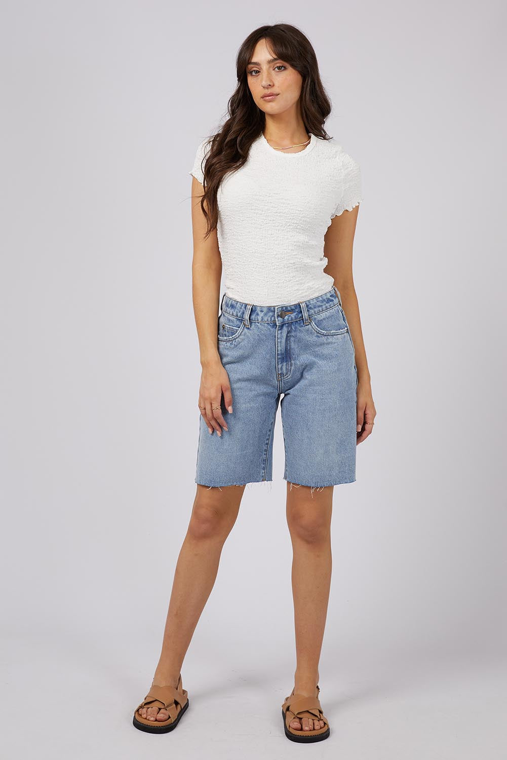 A model wearing the Lexie Denim Short in colour Lblue (Blue), from the front, showing the whole outfit