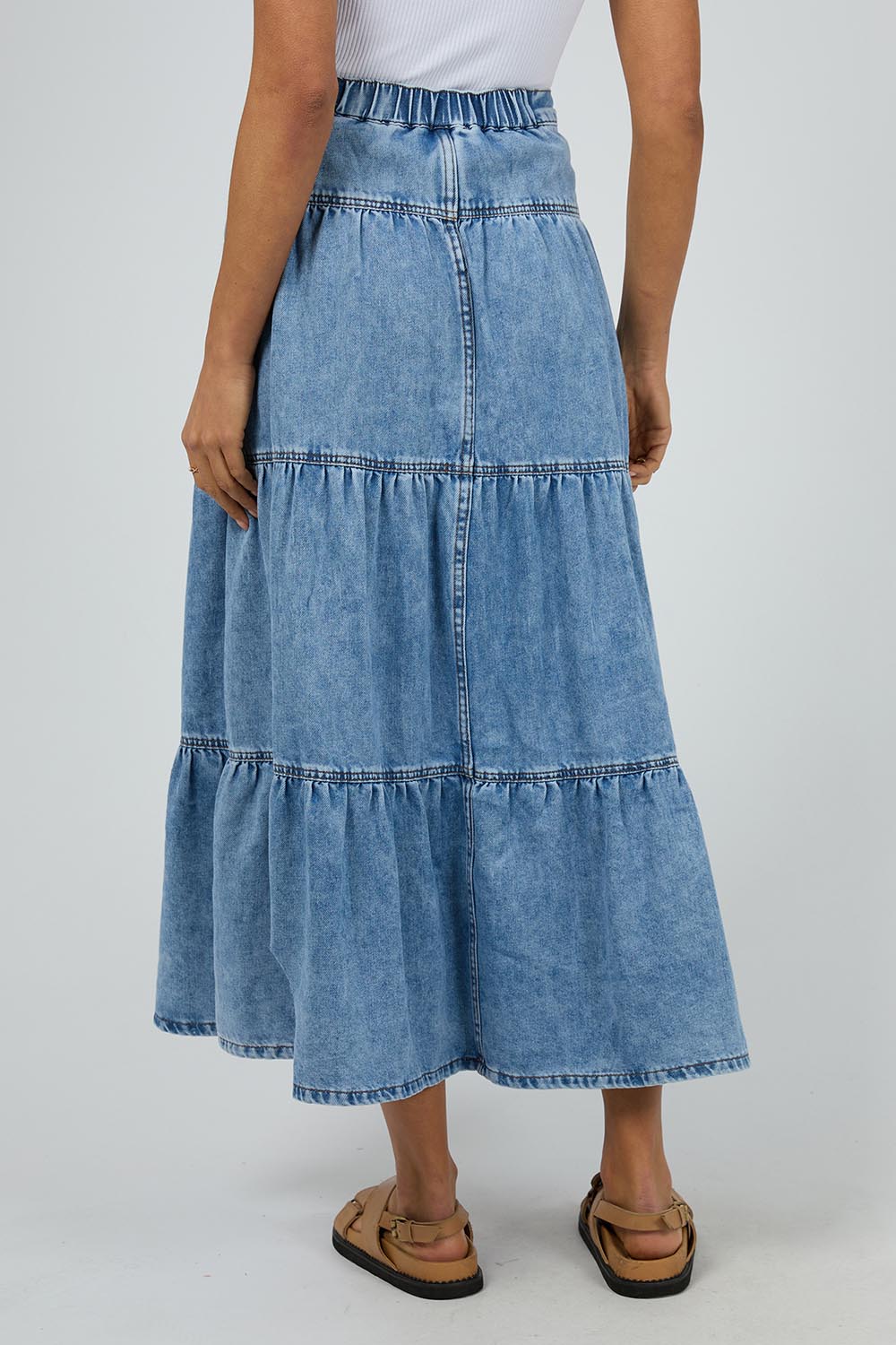 A model wearing the Coco Denim Maxi Skirt in colour Lightblue (Blue), from the back