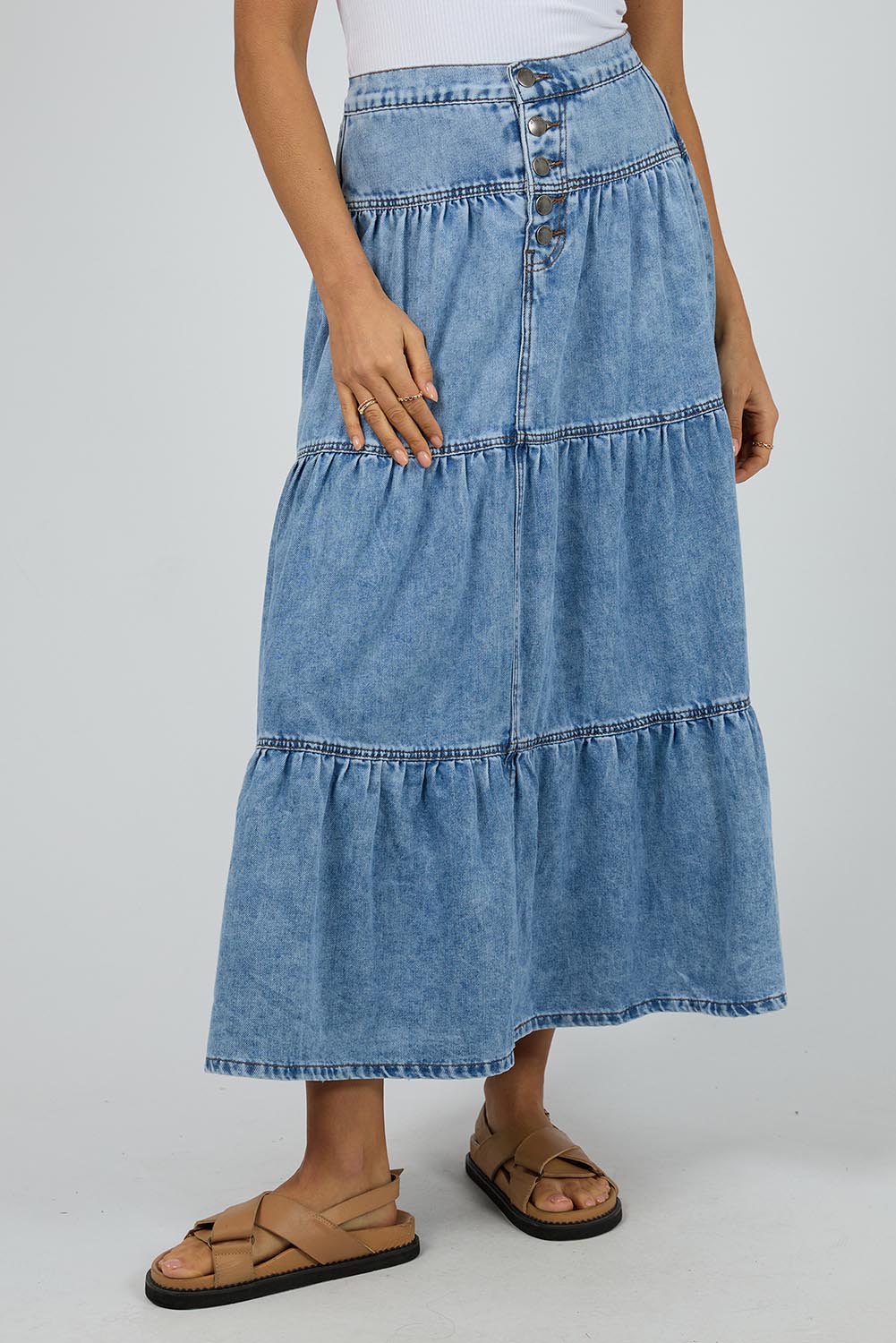 A model wearing the Coco Denim Maxi Skirt in colour Lightblue (Blue), from the front, cropped image