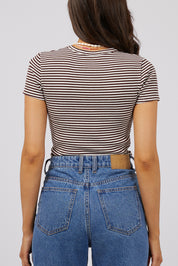 A model wearing the Eve Rib Stripe Tee in colour Brown, from the back