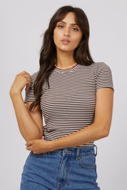 A model wearing the Eve Rib Stripe Tee in colour Brown, from the front, cropped image