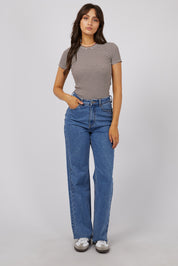 A model wearing the Eve Rib Stripe Tee in colour Brown, from the front, showing the whole outfit