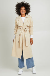 Model Olivia wearing size 10 of the Eve Trench Coat in colour Tan, from the front, showing the whole outfit